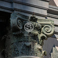 Decorative stone column with intricate carvings on a building facade.